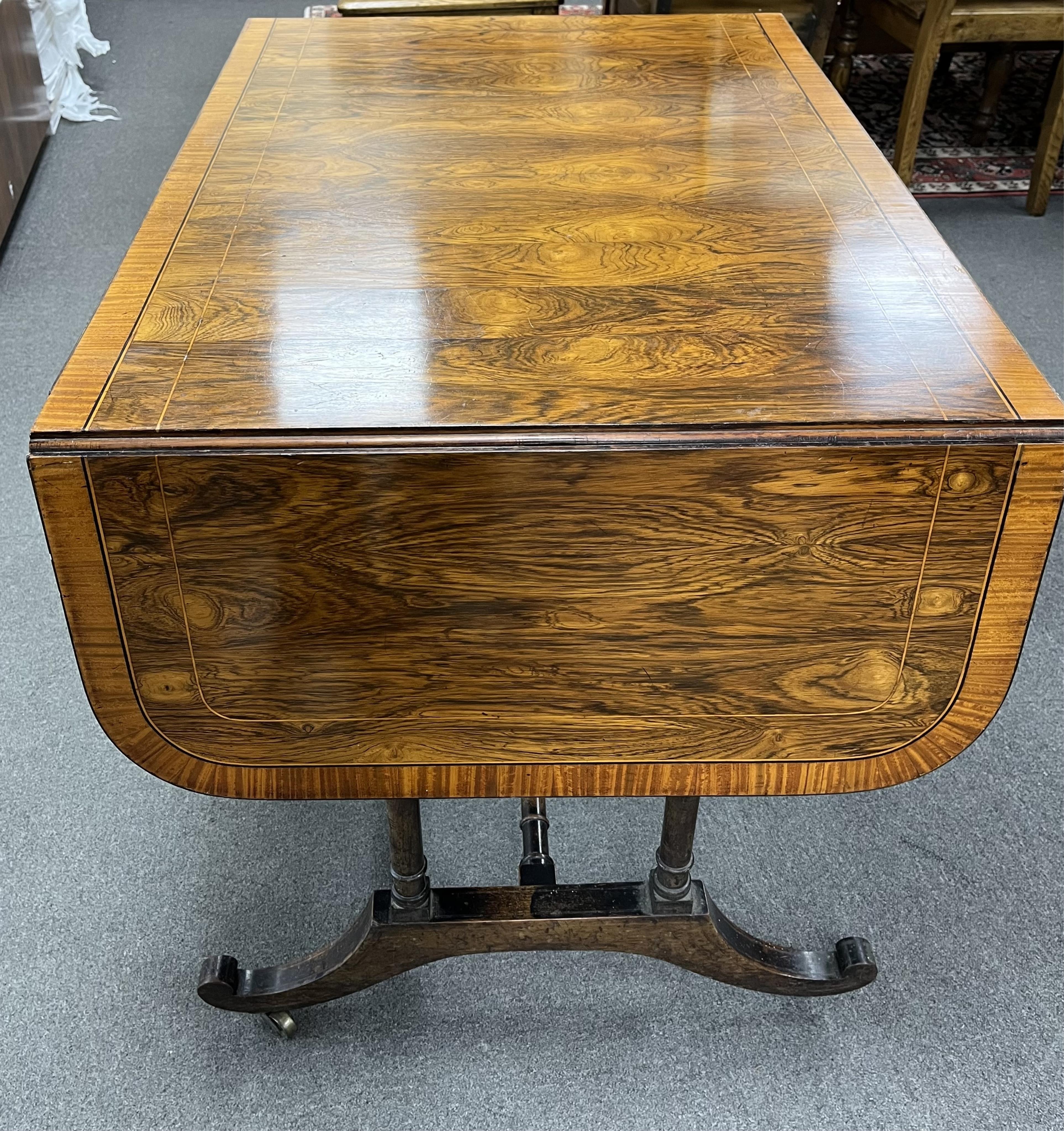 A Regency satinwood banded rosewood sofa table, width 92cm, depth 66cm, height 71cm. Condition - fair
